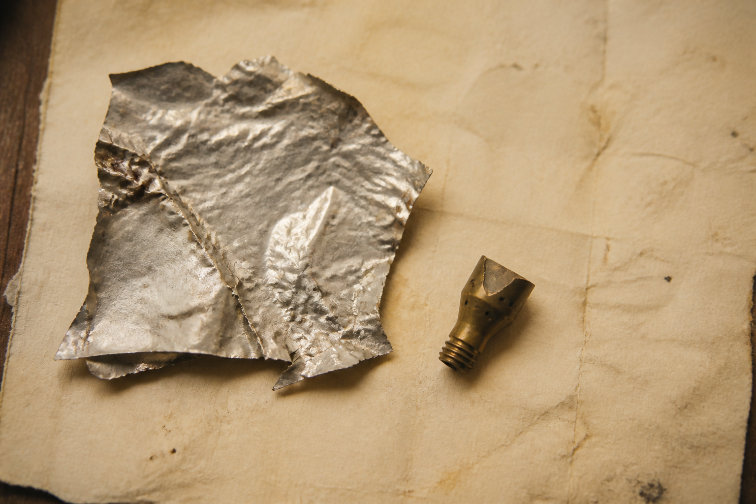 Thermal foil and a brass intake fragment on blotter. The propellant is the air.
